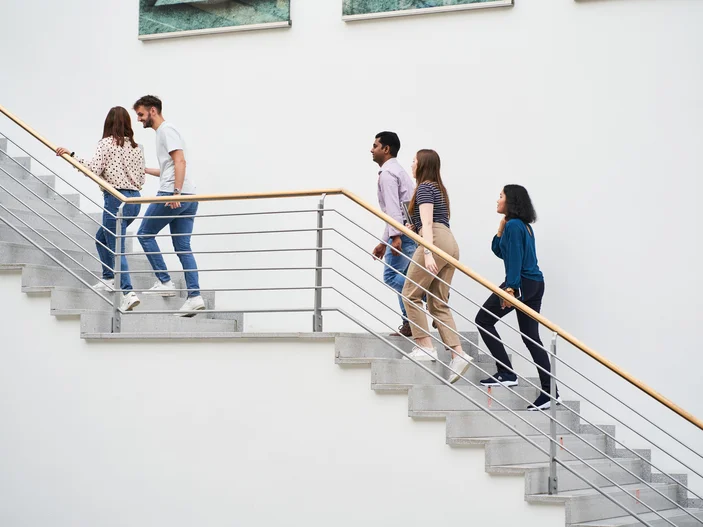 Personen gehen die Treppe im Foyer der Zentralbibliothek hoch